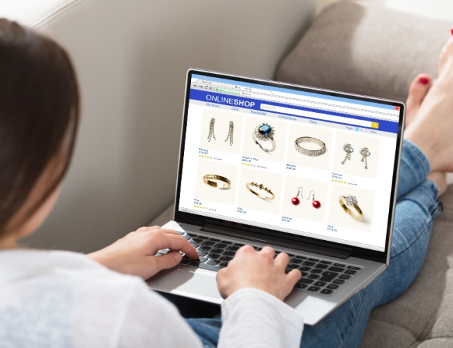 a lady working on jewelry marketing on her laptop