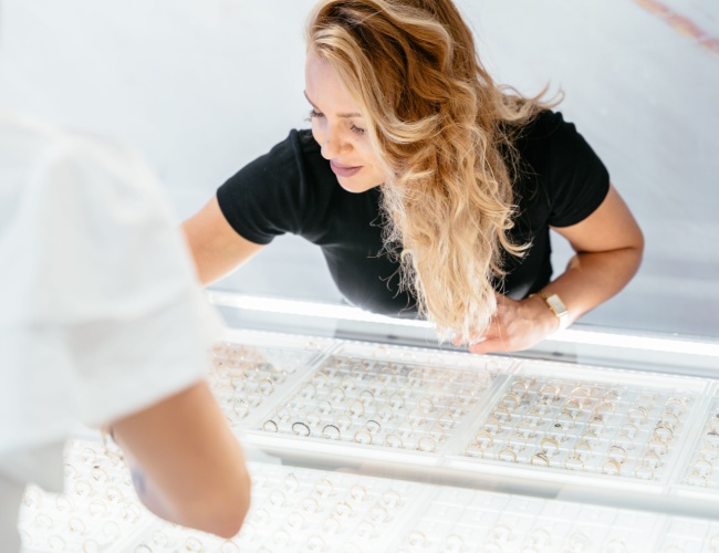 a jeweler retrieving a ring from a display case