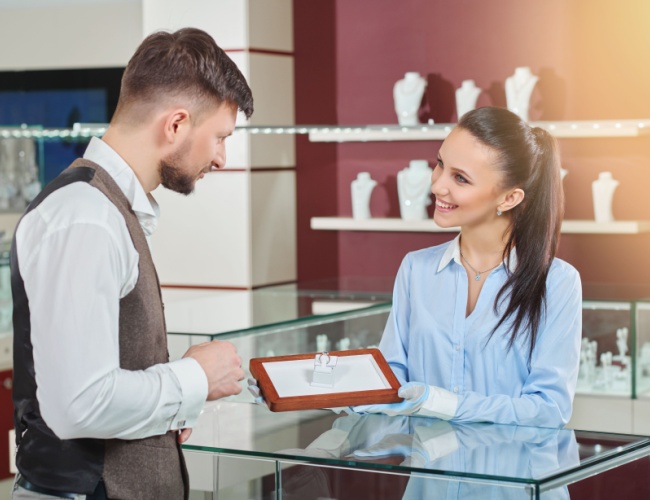 A jeweler showing a ring to a customer